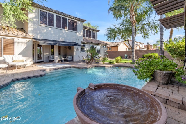 view of swimming pool with an in ground hot tub and a patio area