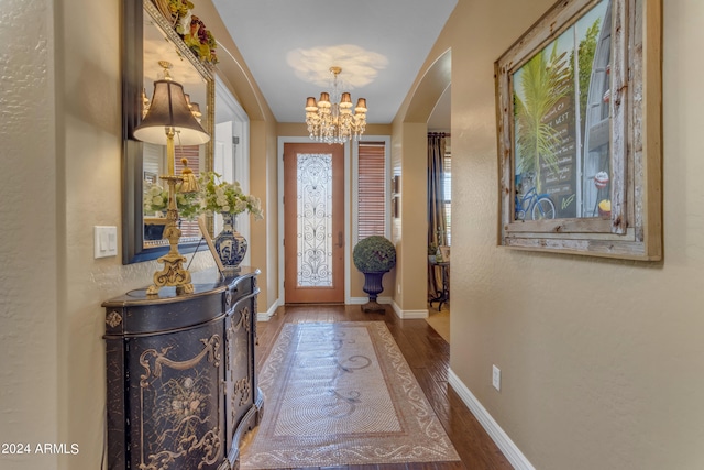 foyer with a notable chandelier and dark hardwood / wood-style flooring