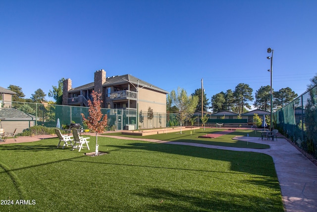 view of property's community with a lawn