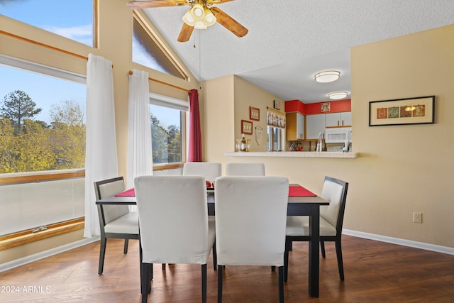 dining area with a textured ceiling, ceiling fan, lofted ceiling, and hardwood / wood-style flooring