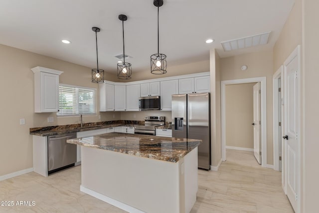 14646 S Brook Hollow Rd, Arizona City, AZ 85123 - kitchen featuring visible vents, a sink, a kitchen island, white cabinets, and appliances with stainless steel finishes