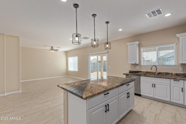 14646 S Brook Hollow Rd, Arizona City, AZ 85123 - kitchen featuring stainless steel dishwasher, ceiling fan, a center island, and visible vents
