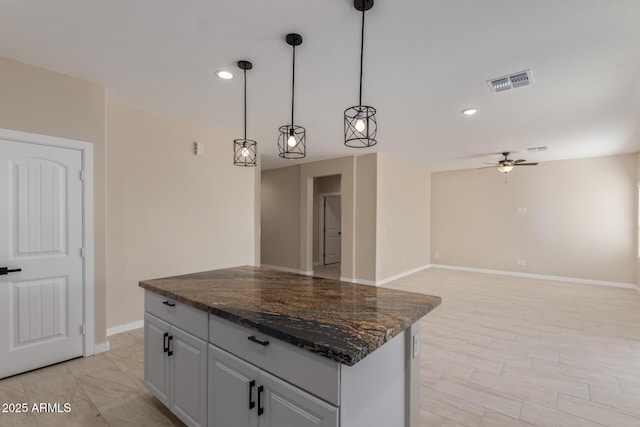 14646 S Brook Hollow Rd, Arizona City, AZ 85123 - kitchen with a ceiling fan, visible vents, baseboards, a kitchen island, and recessed lighting