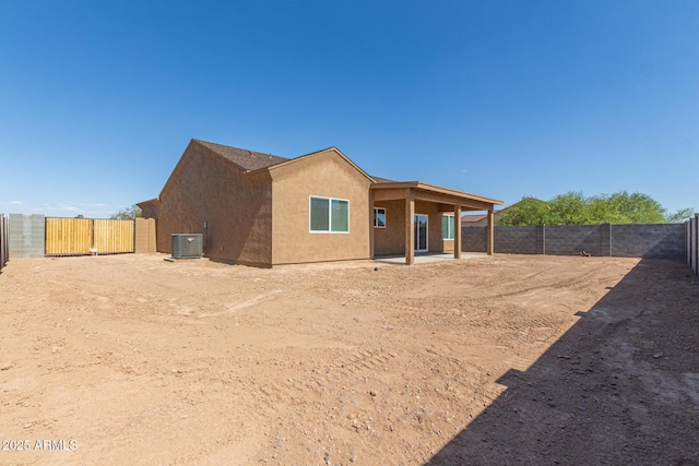 14646 S Brook Hollow Rd, Arizona City, AZ 85123 - rear view of house with central AC unit, stucco siding, a fenced backyard, and a patio area