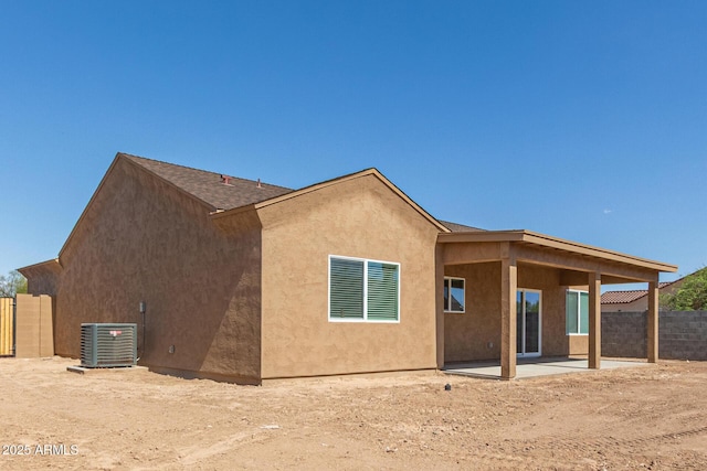 14646 S Brook Hollow Rd, Arizona City, AZ 85123 - rear view of house featuring central AC, stucco siding, fence, a shingled roof, and a patio area