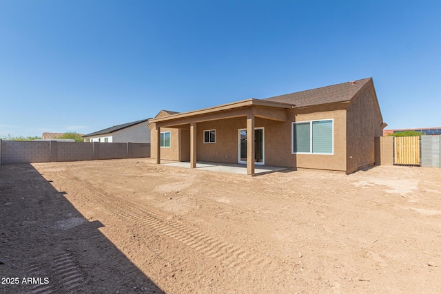 14646 S Brook Hollow Rd, Arizona City, AZ 85123 - back of house with a fenced backyard, a patio area, and stucco siding