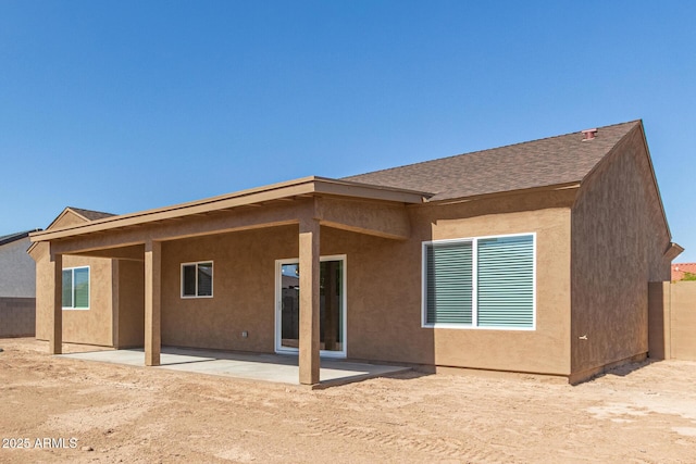 14646 S Brook Hollow Rd, Arizona City, AZ 85123 - rear view of property with a patio area, roof with shingles, stucco siding, and fence