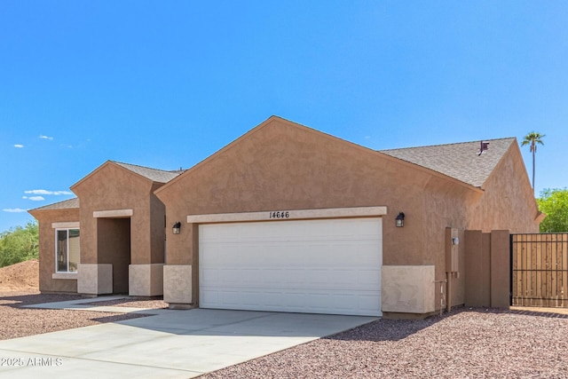 14646 S Brook Hollow Rd, Arizona City, AZ 85123 - view of front of house featuring driveway, fence, an attached garage, stucco siding, and roof with shingles