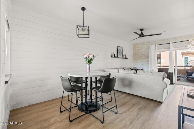 dining space with hardwood / wood-style flooring and ceiling fan