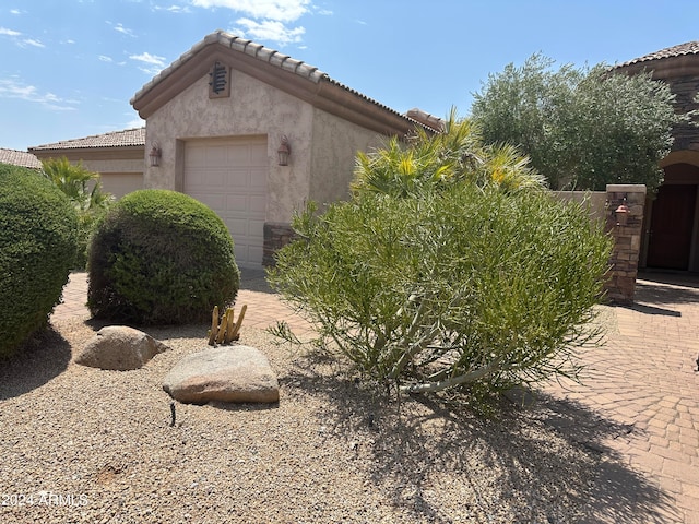 view of side of home featuring a garage