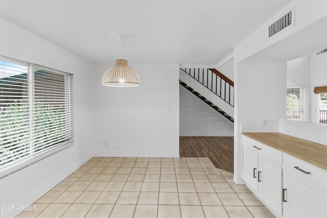 18206 N 45th Ave, Glendale, AZ 85308 - unfurnished dining area featuring stairway and light wood-style floors