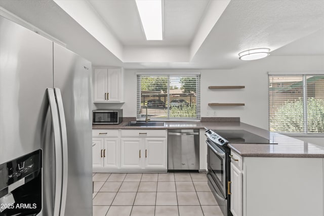 18206 N 45th Ave, Glendale, AZ 85308 - kitchen with stainless steel appliances, a sink, a peninsula, white cabinetry, and light tile patterned floors