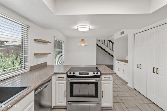 18206 N 45th Ave, Glendale, AZ 85308 - kitchen with appliances with stainless steel finishes, white cabinets, a peninsula, light tile patterned flooring, and a sink