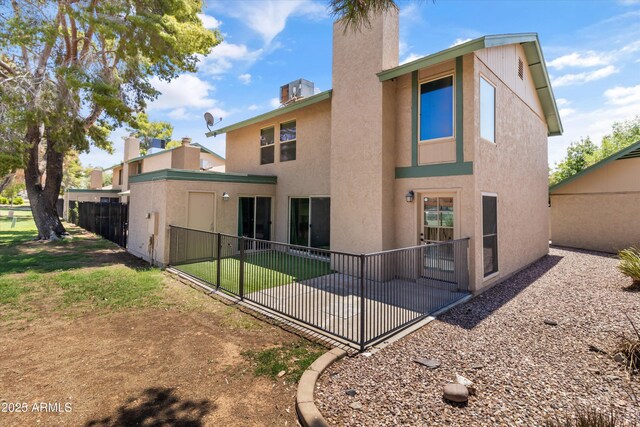 18206 N 45th Ave, Glendale, AZ 85308 - back of property with a chimney, stucco siding, and a patio area