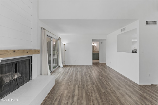 18206 N 45th Ave, Glendale, AZ 85308 - unfurnished living room featuring wood finished floors and a large fireplace