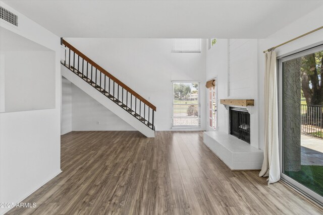 18206 N 45th Ave, Glendale, AZ 85308 - unfurnished living room with wood finished floors, stairs, and a fireplace