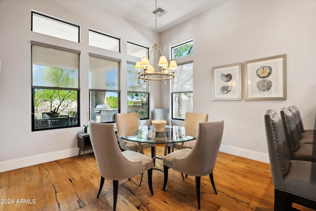 dining space featuring baseboards, visible vents, and hardwood / wood-style floors