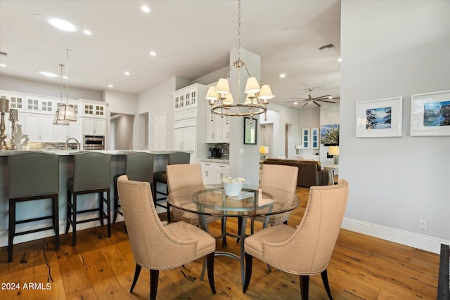 dining space featuring recessed lighting, ceiling fan with notable chandelier, dark wood-type flooring, visible vents, and baseboards