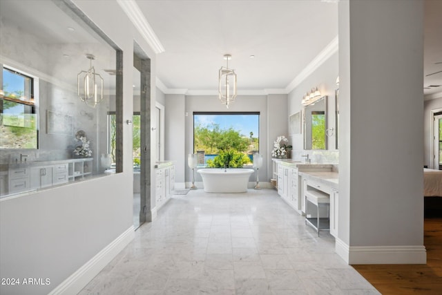 bathroom with a chandelier, a freestanding tub, two vanities, baseboards, and ornamental molding