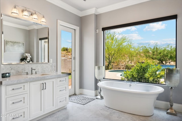 bathroom with vanity, baseboards, a freestanding bath, marble finish floor, and ornamental molding