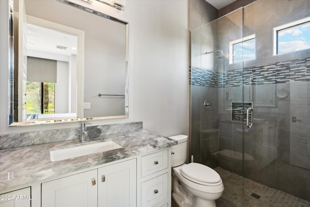 full bathroom featuring visible vents, vanity, a shower stall, and toilet