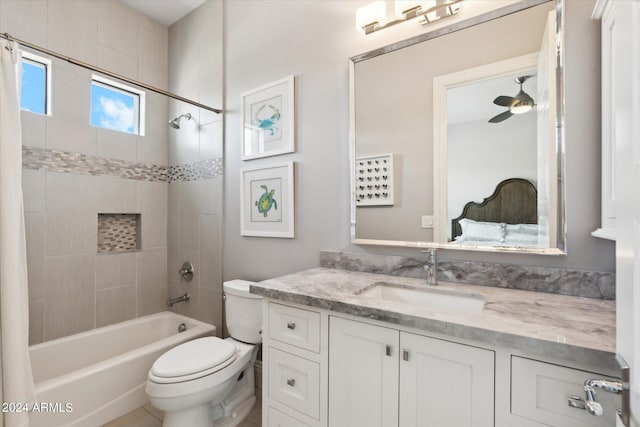 bathroom featuring toilet, a ceiling fan, shower / tub combo with curtain, and vanity