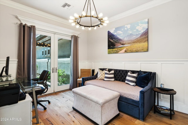 interior space featuring visible vents, wainscoting, crown molding, french doors, and light wood-type flooring