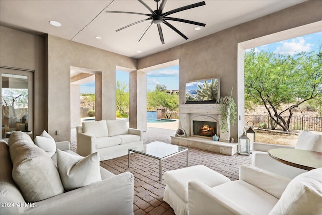 interior space featuring a warm lit fireplace and recessed lighting