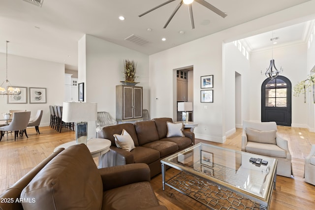 living area with recessed lighting, light wood-type flooring, visible vents, and baseboards