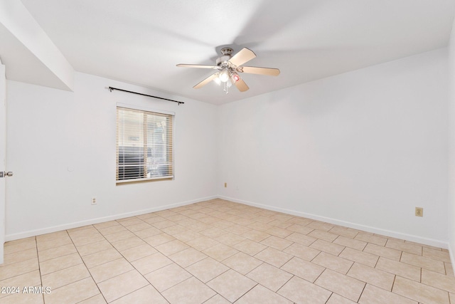 empty room with ceiling fan and light tile patterned floors