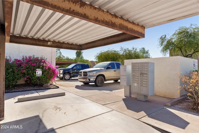 view of vehicle parking with a mail area