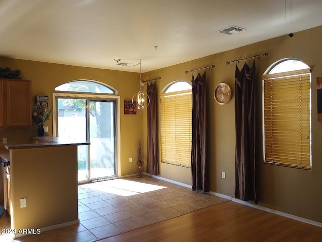 unfurnished dining area featuring light hardwood / wood-style flooring