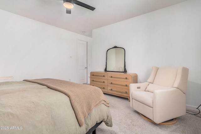 bedroom featuring light colored carpet and a ceiling fan
