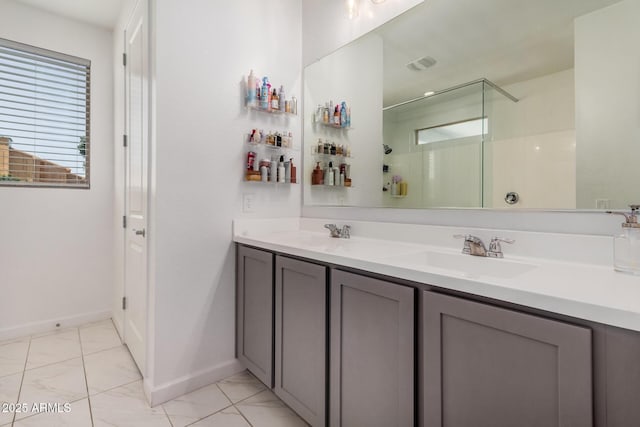 full bath featuring an enclosed shower, marble look tiles, baseboards, and double vanity