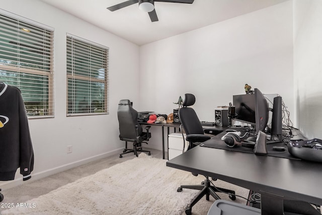 carpeted home office featuring ceiling fan and baseboards