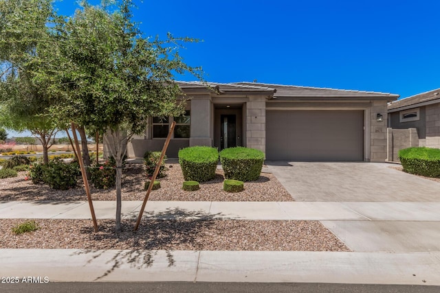 view of front of home featuring an attached garage, driveway, and a tile roof