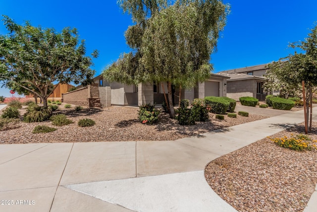 view of front of property with an attached garage and stucco siding