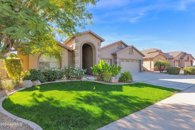 mediterranean / spanish home with a garage and a front yard