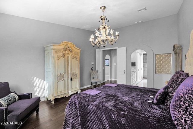 bedroom with dark wood-type flooring and a chandelier