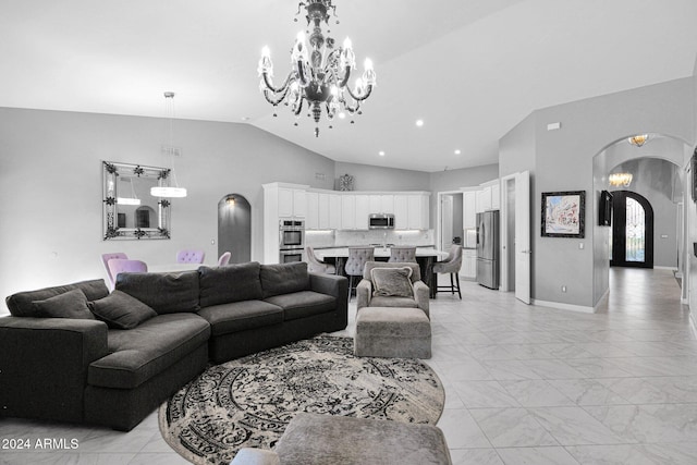 living room with high vaulted ceiling and a notable chandelier