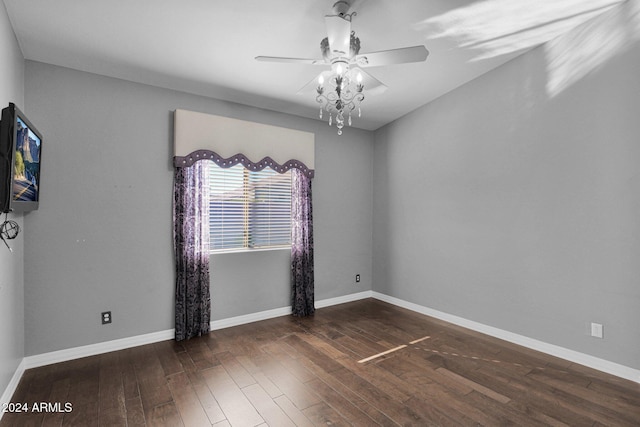 unfurnished room with ceiling fan and dark wood-type flooring