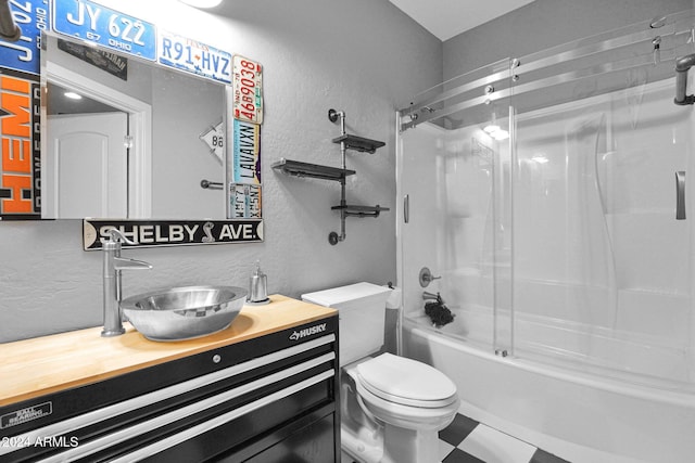 full bathroom with vanity, toilet, and bath / shower combo with glass door