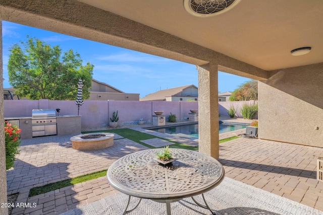 view of patio / terrace featuring a fenced in pool, area for grilling, and an outdoor fire pit