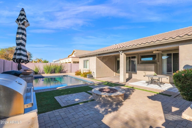 view of pool featuring a patio area and a fire pit