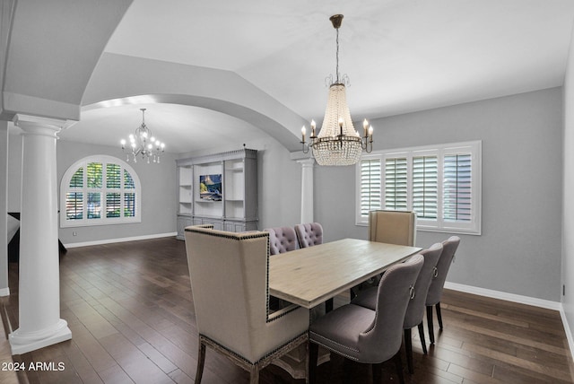 dining space with decorative columns, dark hardwood / wood-style flooring, lofted ceiling, and an inviting chandelier