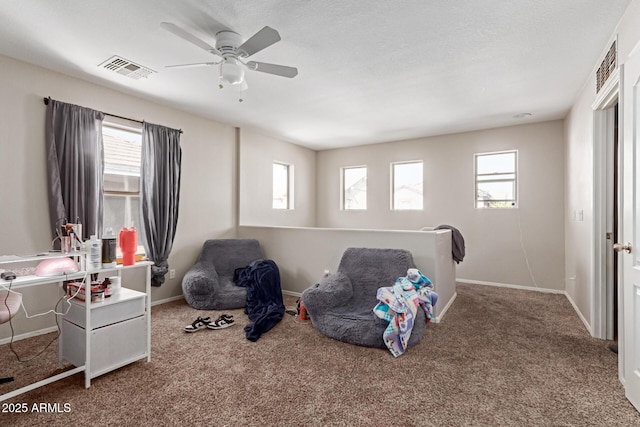 recreation room featuring a healthy amount of sunlight, ceiling fan, and carpet flooring