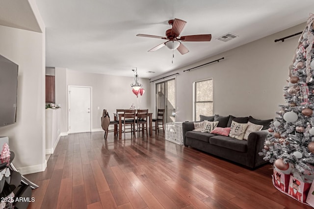 living room with ceiling fan and dark hardwood / wood-style floors