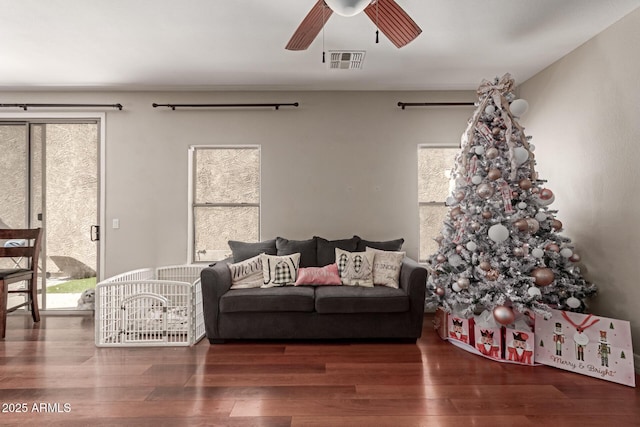 living room with dark hardwood / wood-style flooring and ceiling fan