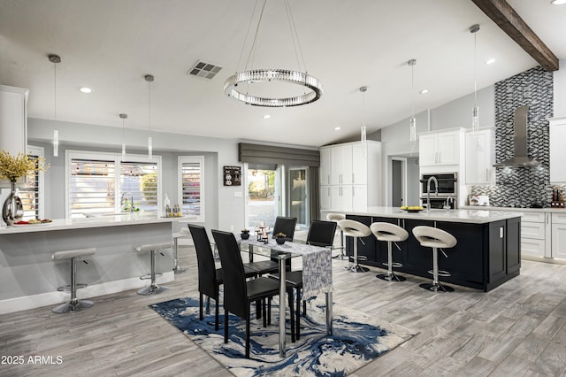 6102 E Nisbet Rd, Scottsdale, AZ 85254 - dining space with lofted ceiling with beams and light hardwood / wood-style floors