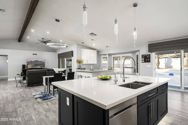 6102 E Nisbet Rd, Scottsdale, AZ 85254 - kitchen with dishwasher, sink, hanging light fixtures, a kitchen island with sink, and light hardwood / wood-style floors